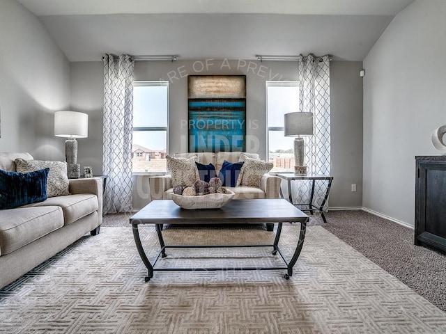 living area featuring a wealth of natural light, light colored carpet, and baseboards