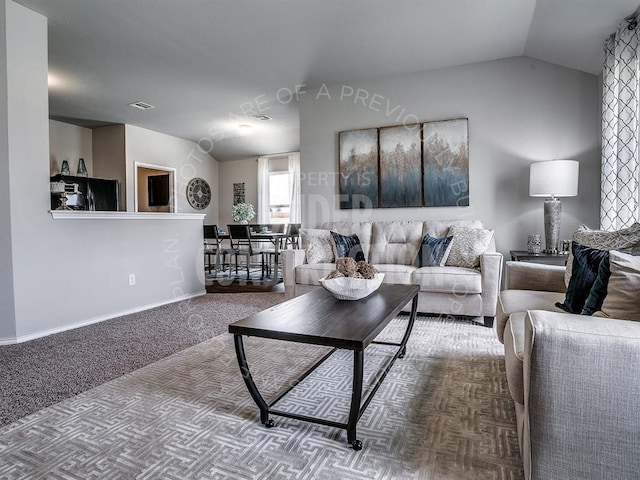 carpeted living area with lofted ceiling, visible vents, and baseboards