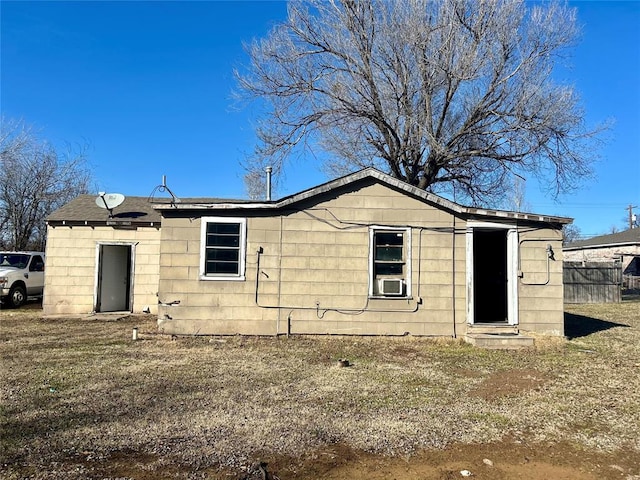 rear view of property with fence and cooling unit