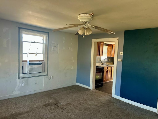 spare room with dark carpet, a sink, baseboards, and a ceiling fan