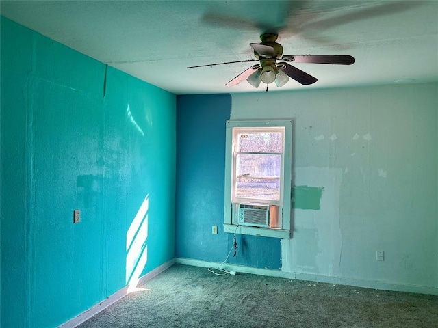 carpeted empty room featuring a ceiling fan, cooling unit, and baseboards