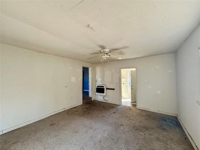 interior space featuring heating unit, a ceiling fan, baseboards, and carpet flooring