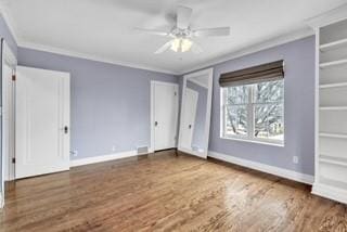 unfurnished bedroom featuring ornamental molding, a ceiling fan, baseboards, and wood finished floors