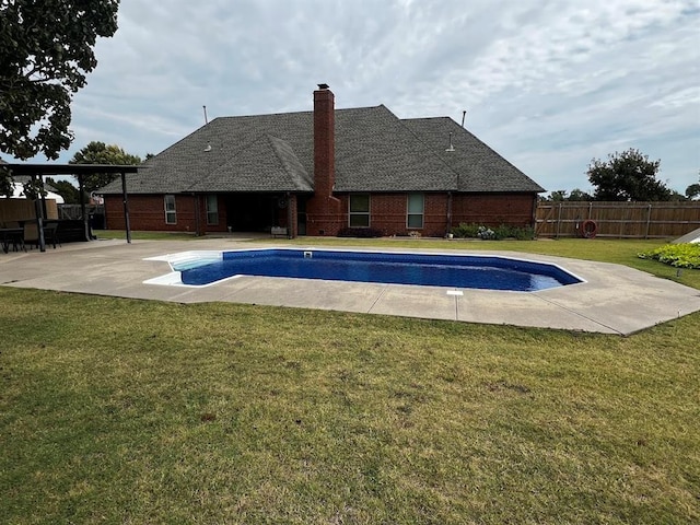 view of pool with a fenced in pool, a patio area, fence, and a lawn