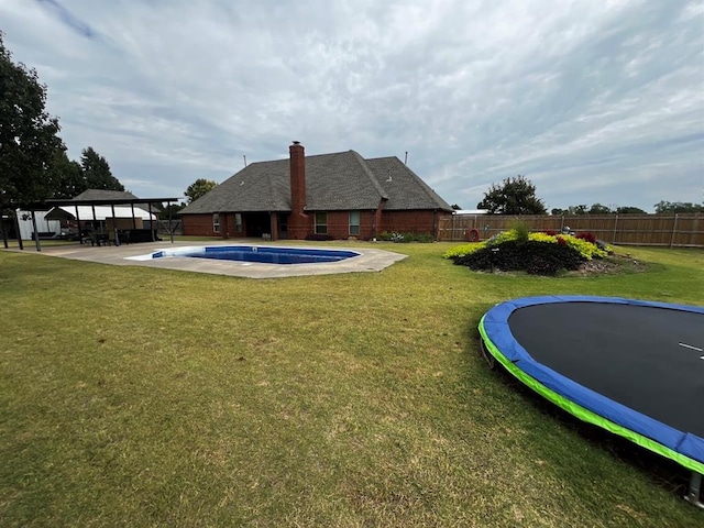 exterior space with a patio, fence private yard, a gazebo, a trampoline, and a yard