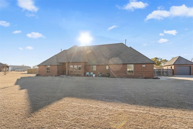 back of house featuring brick siding