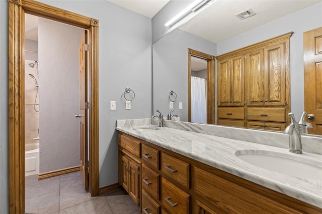 full bathroom with tile patterned flooring, visible vents, a sink, and double vanity