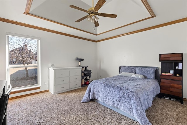 bedroom with ornamental molding, a raised ceiling, carpet flooring, and ceiling fan