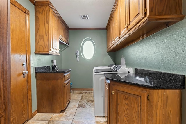 clothes washing area featuring cabinet space, baseboards, visible vents, ornamental molding, and washer and dryer