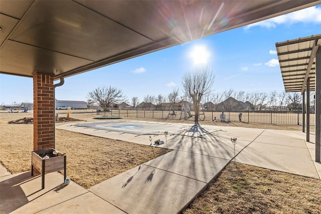 view of patio with a fenced backyard and a community pool