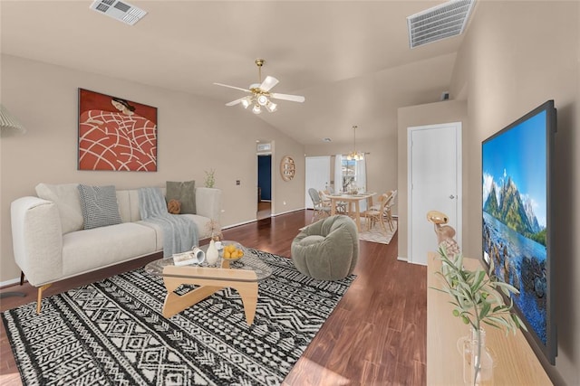 living area with a ceiling fan, visible vents, vaulted ceiling, and wood finished floors