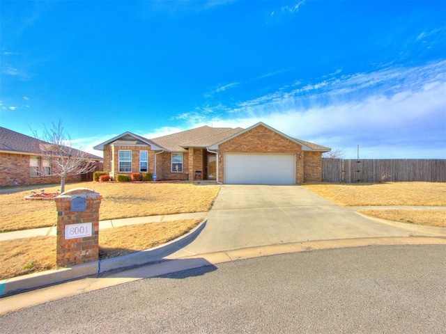 ranch-style home featuring a garage, driveway, fence, and brick siding