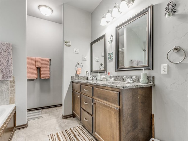 full bath featuring tile patterned flooring, a sink, baseboards, a bath, and double vanity