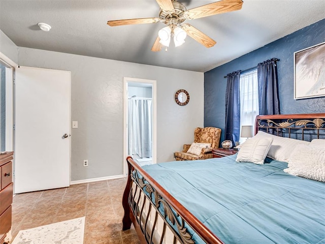 bedroom featuring a textured wall, ceiling fan, and baseboards