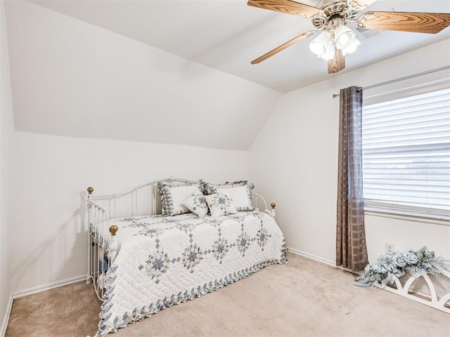 bedroom featuring vaulted ceiling, carpet, a ceiling fan, and baseboards