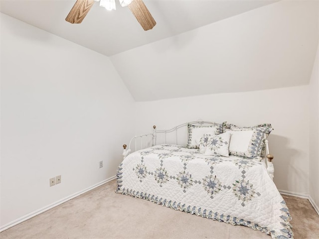 bedroom featuring carpet flooring, vaulted ceiling, baseboards, and ceiling fan