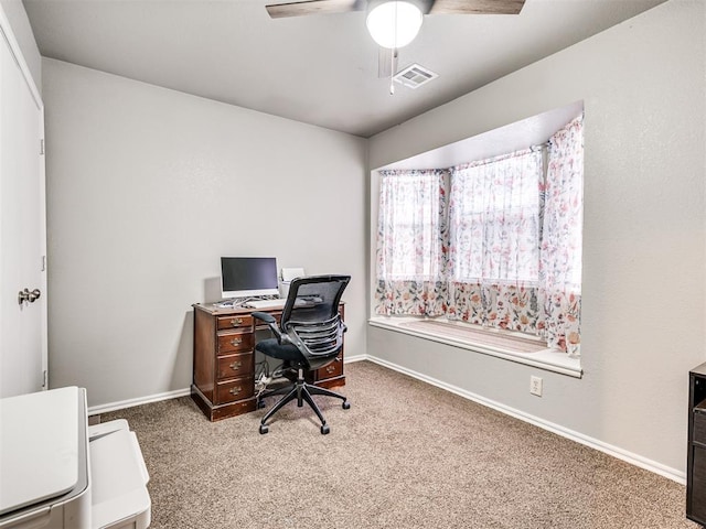 home office featuring ceiling fan, carpet, visible vents, and baseboards