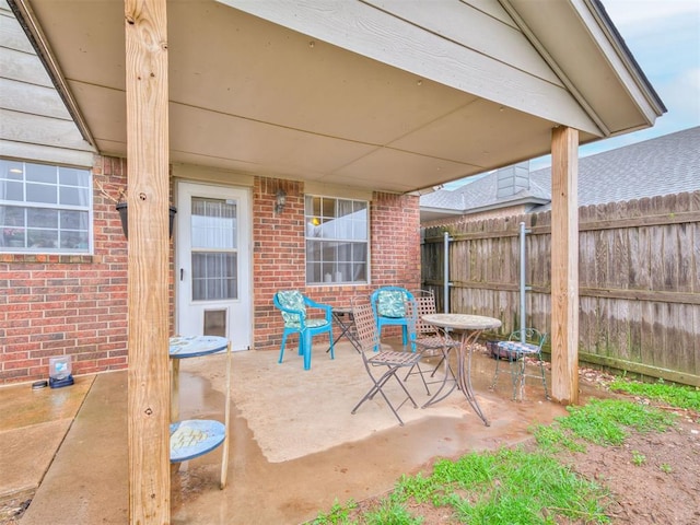 view of patio / terrace featuring fence