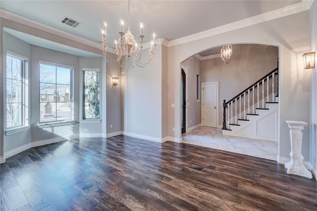 interior space featuring stairs, wood finished floors, visible vents, and an inviting chandelier