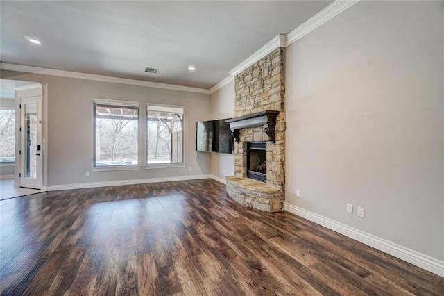 unfurnished living room with a stone fireplace, recessed lighting, baseboards, ornamental molding, and dark wood-style floors