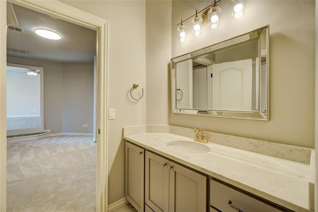 bathroom featuring a ceiling fan, vanity, visible vents, and baseboards