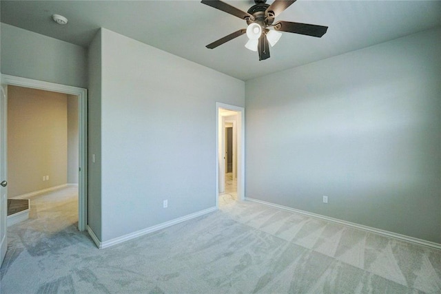 unfurnished bedroom featuring baseboards, a ceiling fan, and light colored carpet