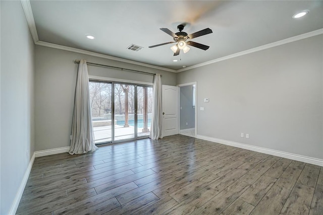 unfurnished room featuring ornamental molding, visible vents, baseboards, and wood finished floors