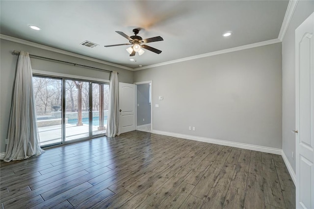 unfurnished room with baseboards, visible vents, ornamental molding, and wood finished floors