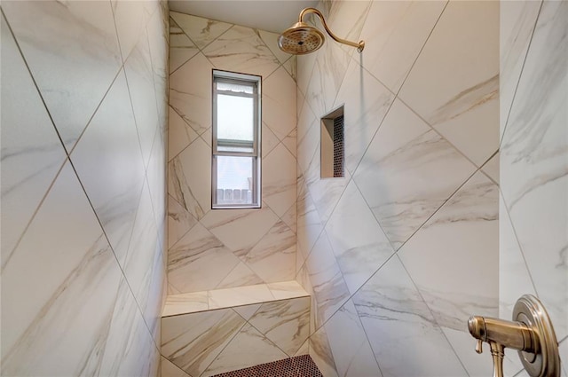 bathroom with a marble finish shower