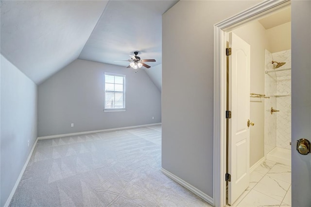 additional living space with vaulted ceiling, ceiling fan, light carpet, and baseboards