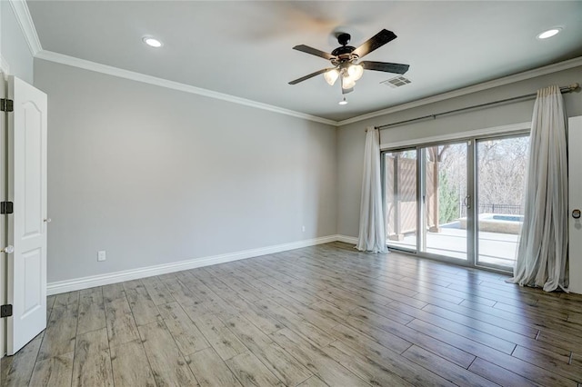 unfurnished room featuring visible vents, ornamental molding, light wood-style flooring, and baseboards