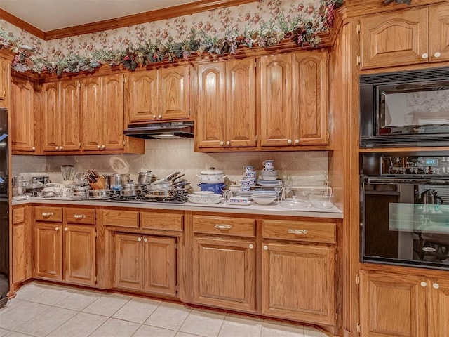 16632 Parkhurst Rd, Edmond, OK 73012 - kitchen with black appliances, under cabinet range hood, decorative backsplash, light tile patterned flooring, and light countertops