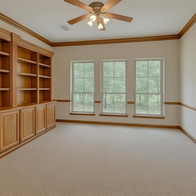 16632 Parkhurst Rd, Edmond, OK 73012 - unfurnished room with light colored carpet, plenty of natural light, ceiling fan, and ornamental molding
