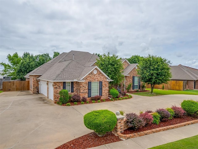 16632 Parkhurst Rd, Edmond, OK 73012 - view of front facade featuring concrete driveway, brick siding, an attached garage, and roof with shingles