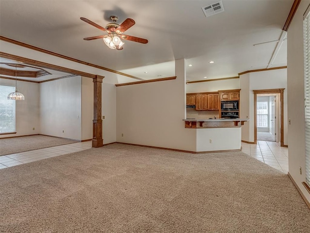 16632 Parkhurst Rd, Edmond, OK 73012 - unfurnished living room featuring light carpet, light tile patterned flooring, ornamental molding, ceiling fan, and healthy amount of natural light