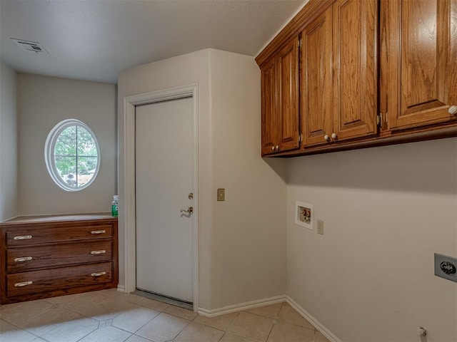16632 Parkhurst Rd, Edmond, OK 73012 - washroom with hookup for an electric dryer, hookup for a washing machine, cabinet space, and light tile patterned floors