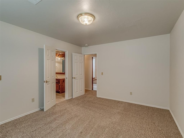 16632 Parkhurst Rd, Edmond, OK 73012 - unfurnished bedroom with light carpet and ensuite bath