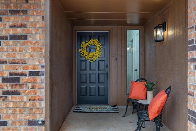 property entrance featuring brick siding