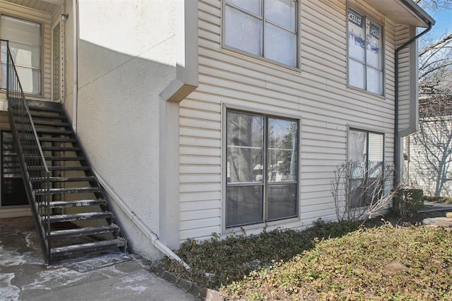 view of home's exterior featuring stairway and stucco siding