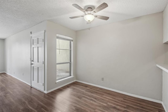 unfurnished room featuring ceiling fan, a textured ceiling, wood finished floors, and baseboards