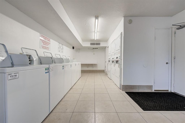 shared laundry area featuring visible vents, mail area, separate washer and dryer, and light tile patterned flooring