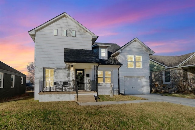 view of front of home with a porch, an attached garage, concrete driveway, a yard, and roof with shingles