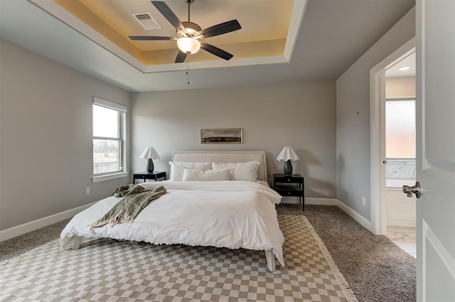 12709 Pinewood Ln, Oklahoma City, OK 73142 - bedroom featuring a raised ceiling, visible vents, a ceiling fan, and baseboards
