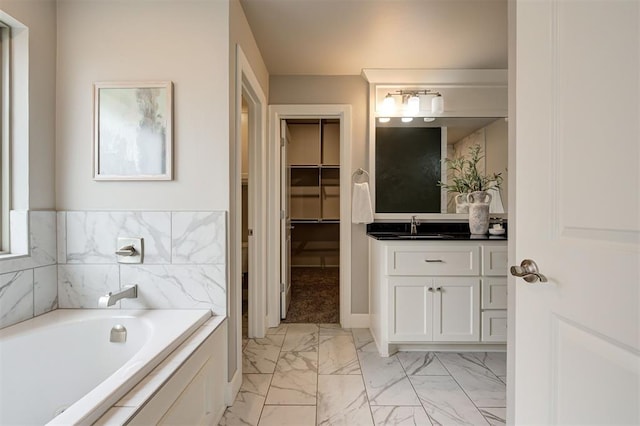 12709 Pinewood Ln, Oklahoma City, OK 73142 - full bathroom featuring a walk in closet, marble finish floor, a garden tub, and vanity