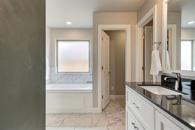 12709 Pinewood Ln, Oklahoma City, OK 73142 - bathroom with recessed lighting, marble finish floor, vanity, baseboards, and a garden tub