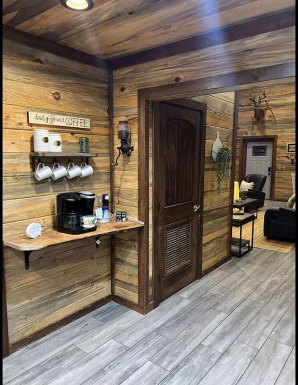 bar featuring wooden ceiling, wood walls, and wood finished floors