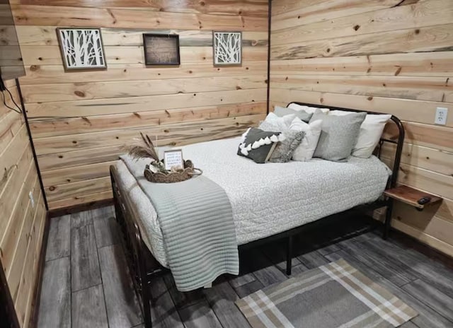 bedroom with wooden walls and wood finished floors