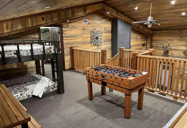 recreation room featuring carpet, wood ceiling, and wood walls