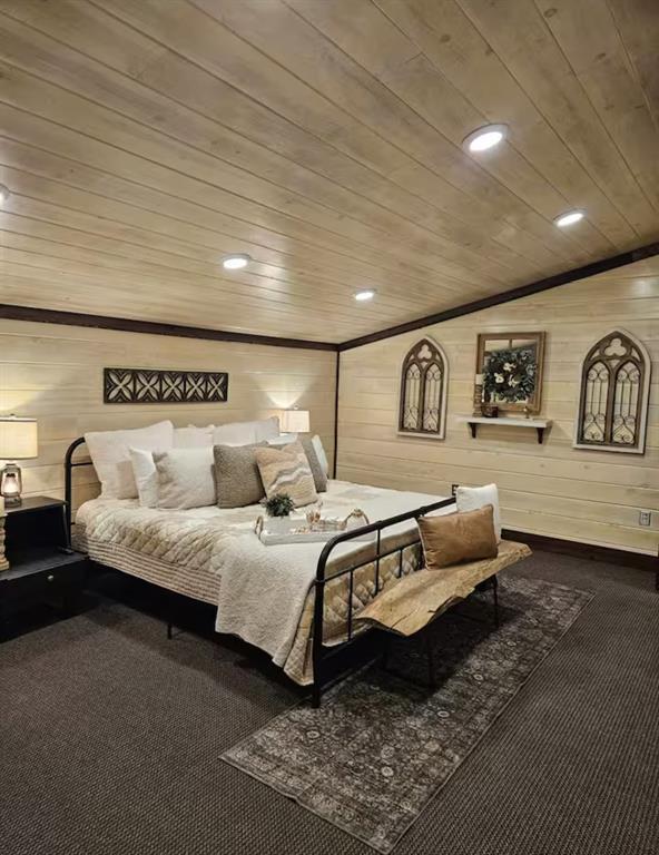 carpeted bedroom featuring wood ceiling, wooden walls, and recessed lighting