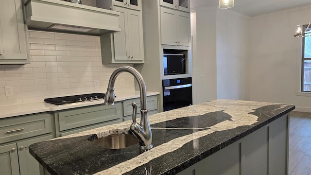 kitchen with oven, premium range hood, wood finished floors, ornamental molding, and decorative backsplash